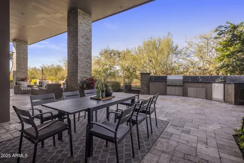 a view of a patio with swimming pool table and chairs