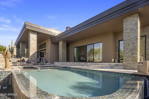 a view of a swimming pool with a lounge chairs