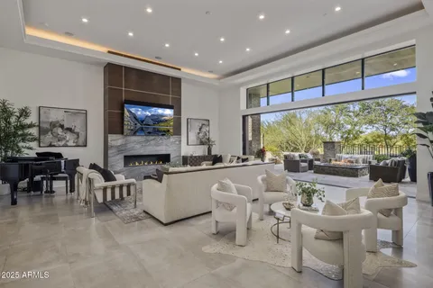 a living room with fireplace furniture and a flat screen tv