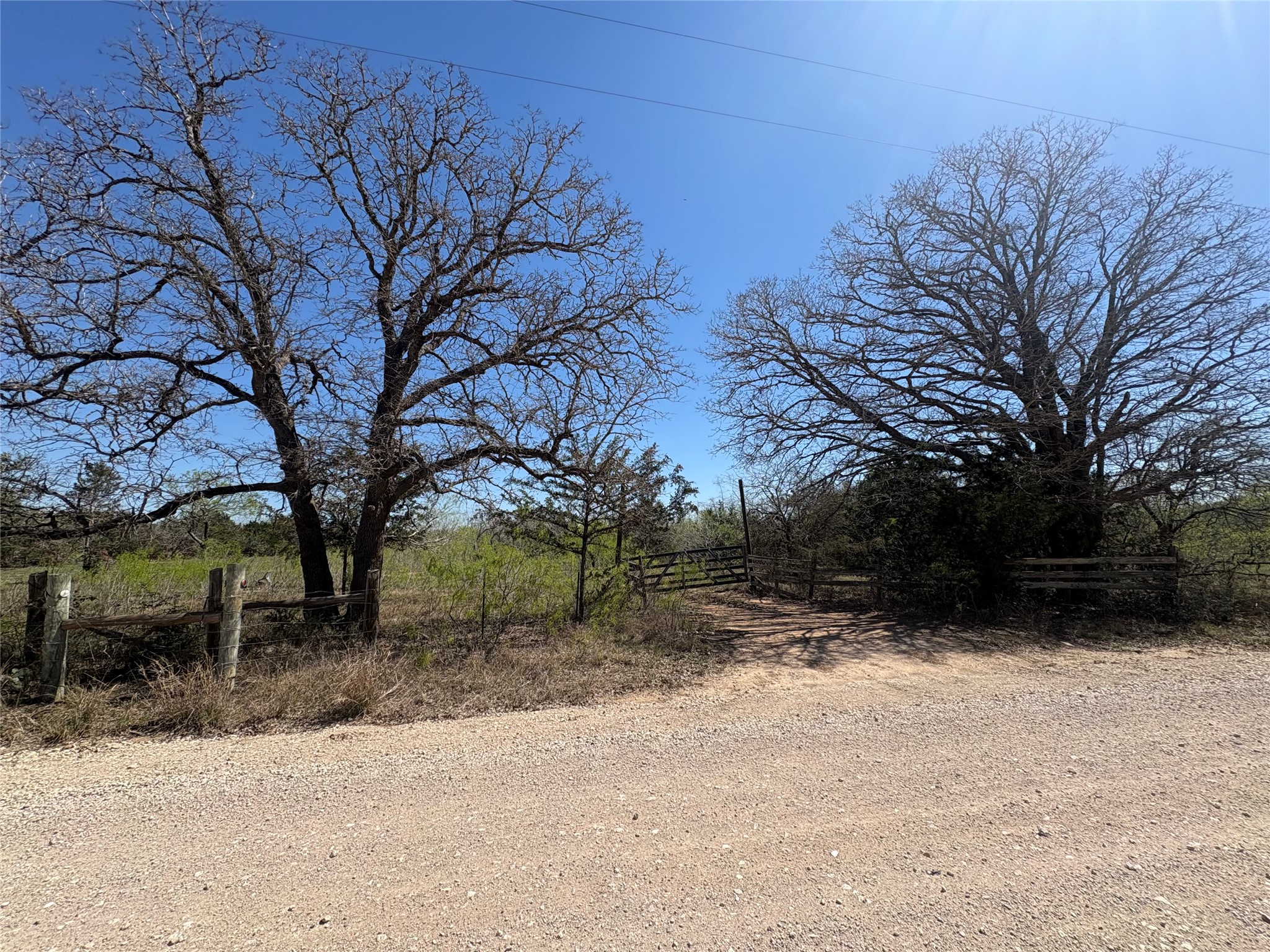 View of dirt / gravel road featuring a view of countryside