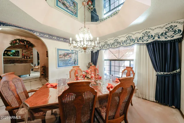 a view of a dining room with furniture and chandelier