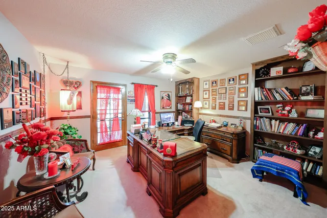 a living room with furniture and a book shelf
