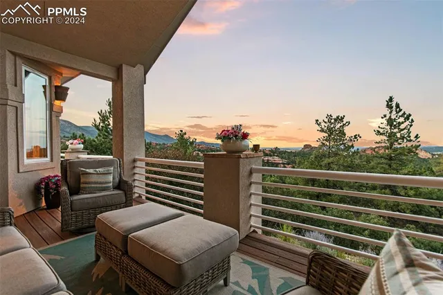a view of a balcony with couches and wooden floor