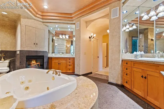 a spacious bathroom with a tub sink and mirror
