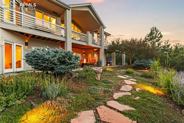 a living room with furniture a flat screen tv and kitchen view