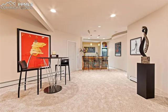 a living room with furniture projector and screen