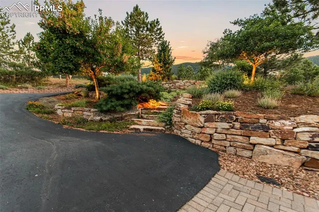 an aerial view of a house with a mountain
