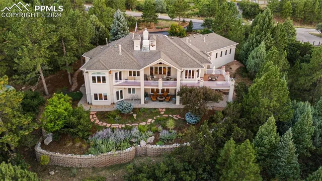 a kitchen with stainless steel appliances wooden floor dining table and chairs