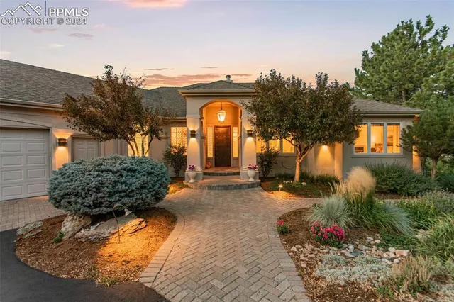 a view of a house with a flower garden