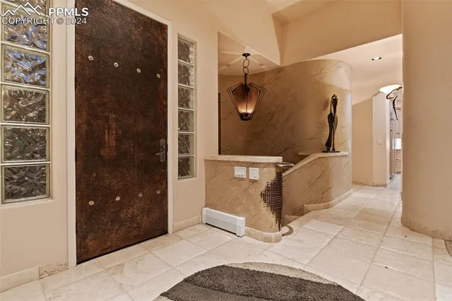 a bathroom with a glass shower door and a sink