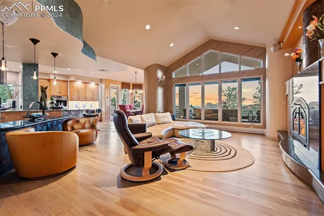 a living room with furniture and a floor to ceiling window
