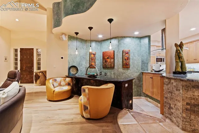 a large kitchen with stainless steel appliances kitchen island granite countertop a table and chairs