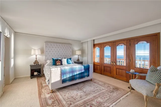 a bedroom with a bed couch and wooden floor