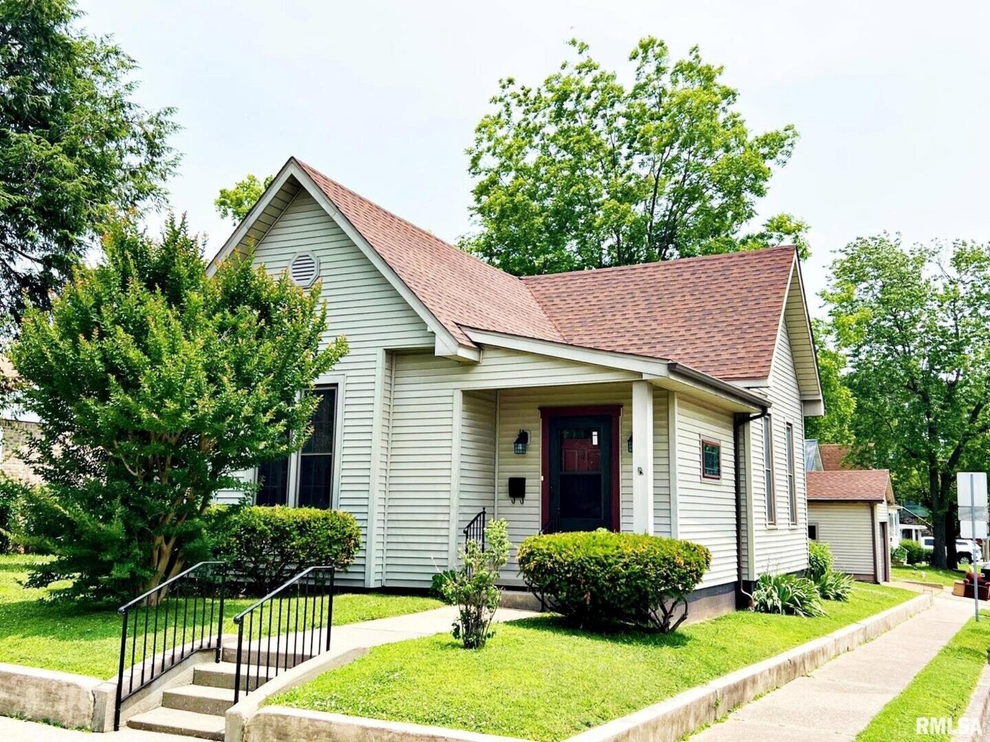 a front view of a house with garden