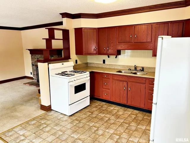 a kitchen with a stove a sink and a refrigerator