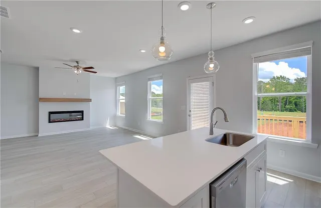 a kitchen with a refrigerator a sink and a fireplace