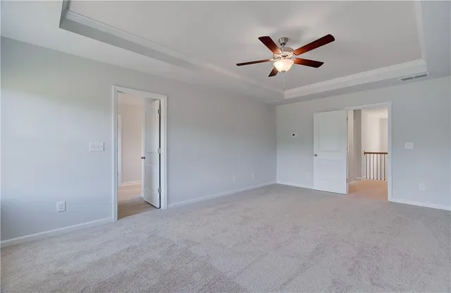 a view of an empty room with a ceiling fan