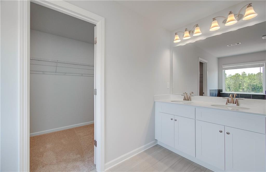 107 Alpine Road Fairburn, GA 30213 - Photo 20 of 22 a bathroom with a sink vanity and a mirror