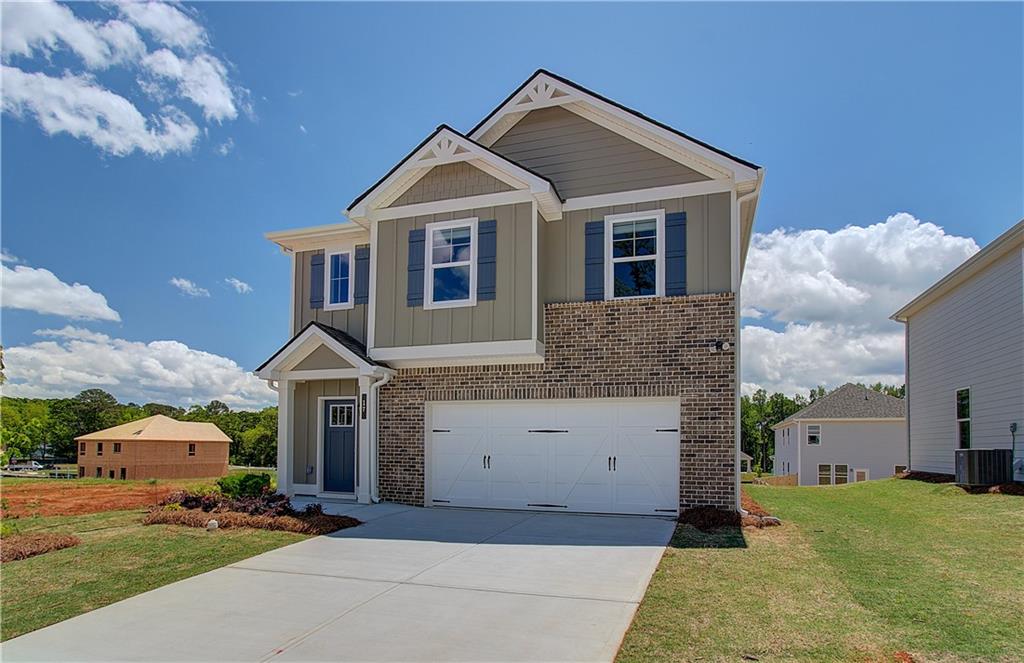107 Alpine Road Fairburn, GA 30213 - Photo 2 of 22 a front view of a house with a yard and garage