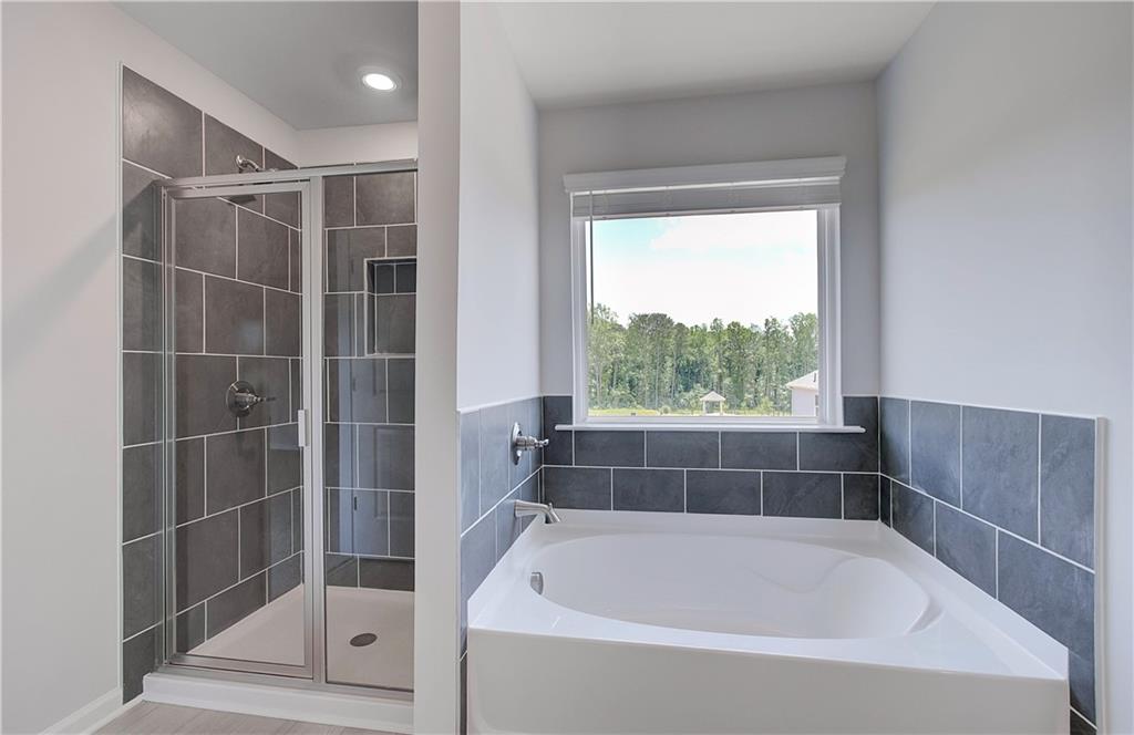 107 Alpine Road Fairburn, GA 30213 - Photo 21 of 22 a bathroom with a bathtub and window