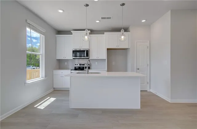 a large white kitchen with a large window