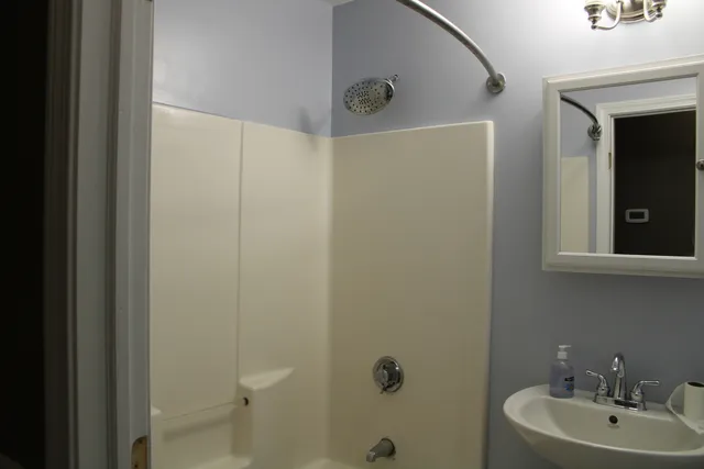 a bathroom with a sink and mirror