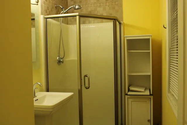 a bathroom with a shower and a sink