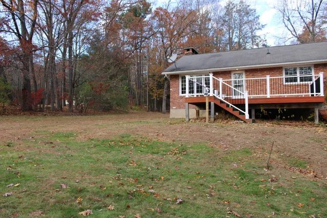 a view of a house with a yard porch and sitting area