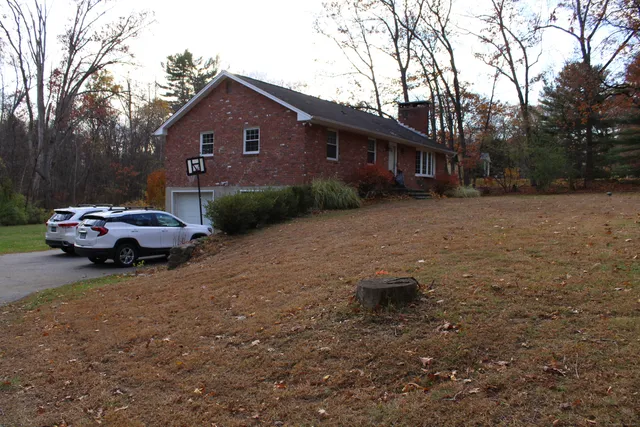 a front view of a house with a garden