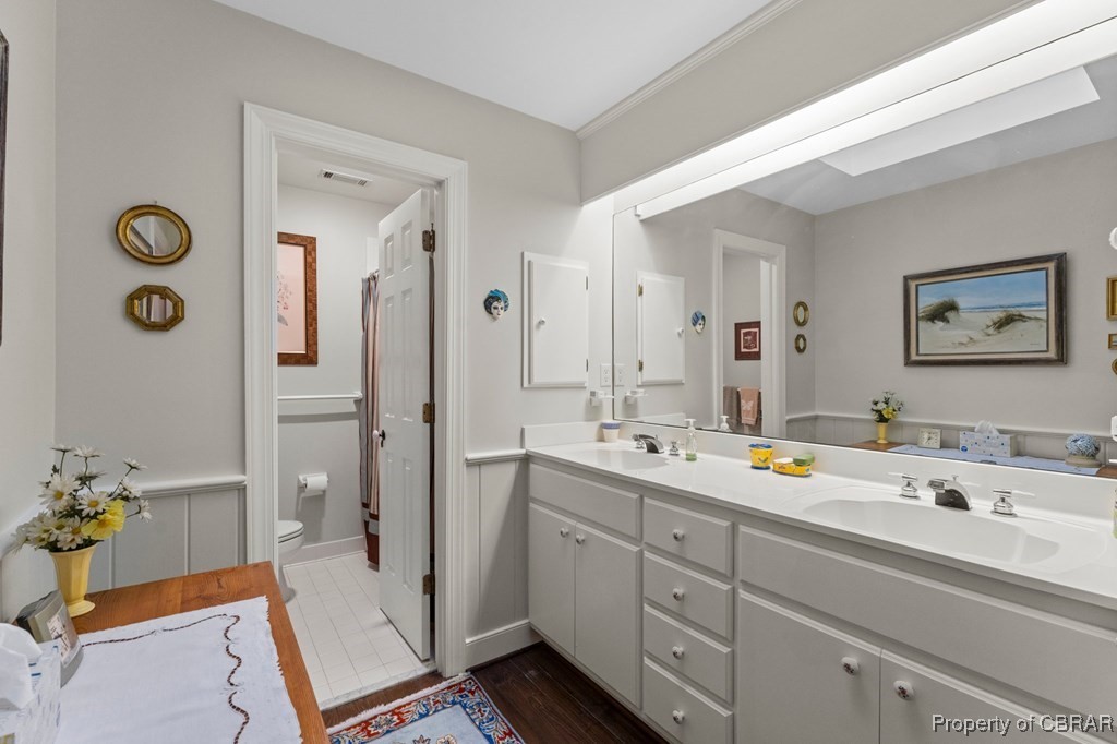 184 York Road Irvington, VA 22480 - Photo 36 of 46 Bathroom featuring vanity, toilet, and wood-type flooring