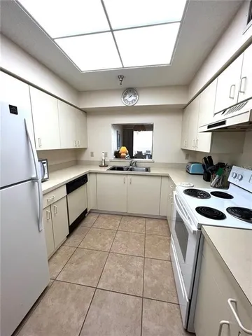 a kitchen with a stove sink and refrigerator