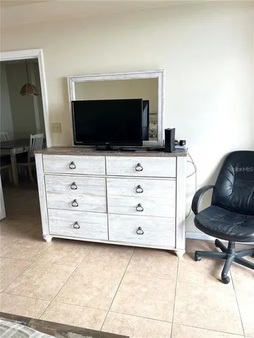 a room with a chair and a flat screen tv