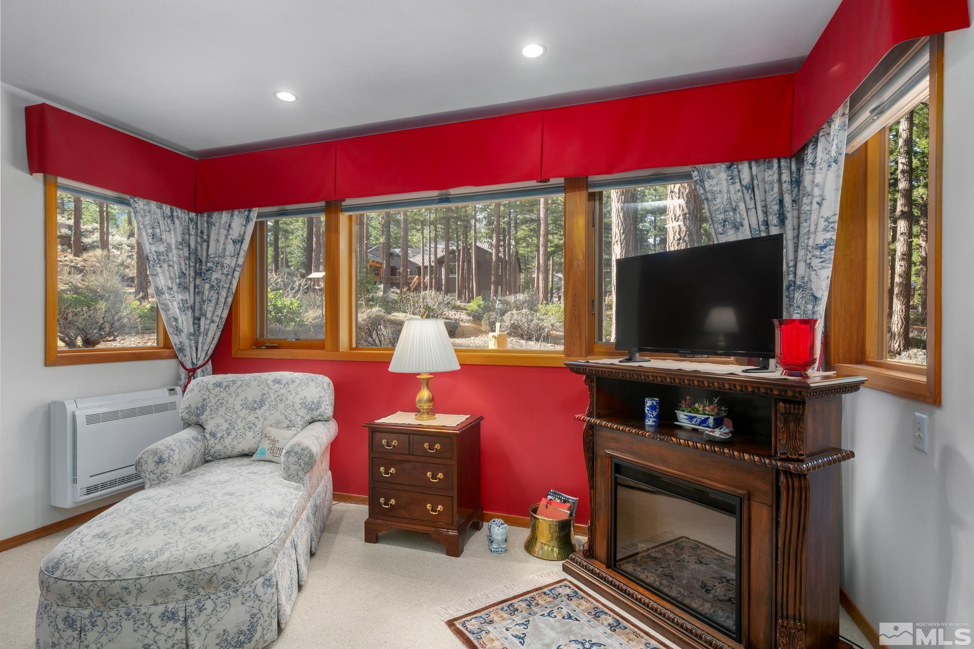 35 Austrian Pine Circle Reno, NV 89511 - Photo 18 of 39 a living room with furniture a flat screen tv and floor to ceiling window