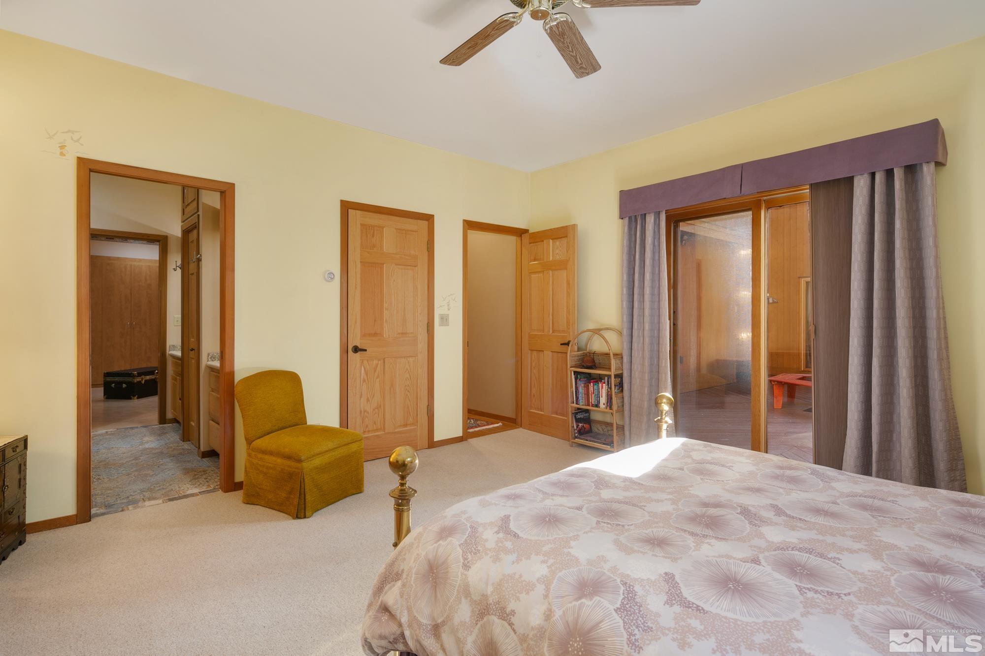35 Austrian Pine Circle Reno, NV 89511 - Photo 26 of 39 a spacious bedroom with a bed a couch and a chandelier