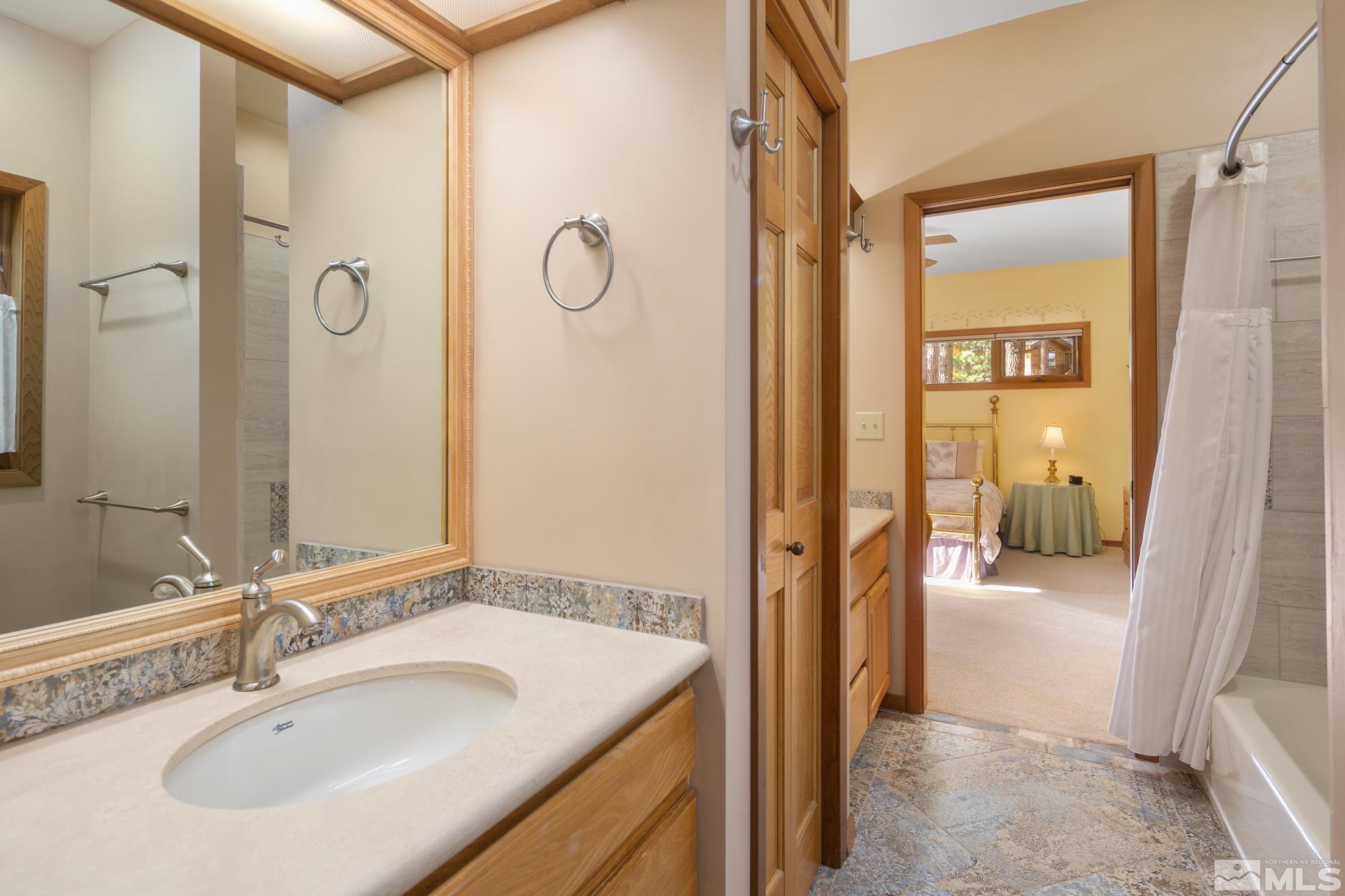 35 Austrian Pine Circle Reno, NV 89511 - Photo 27 of 39 a en suite bathroom with a sink and mirror