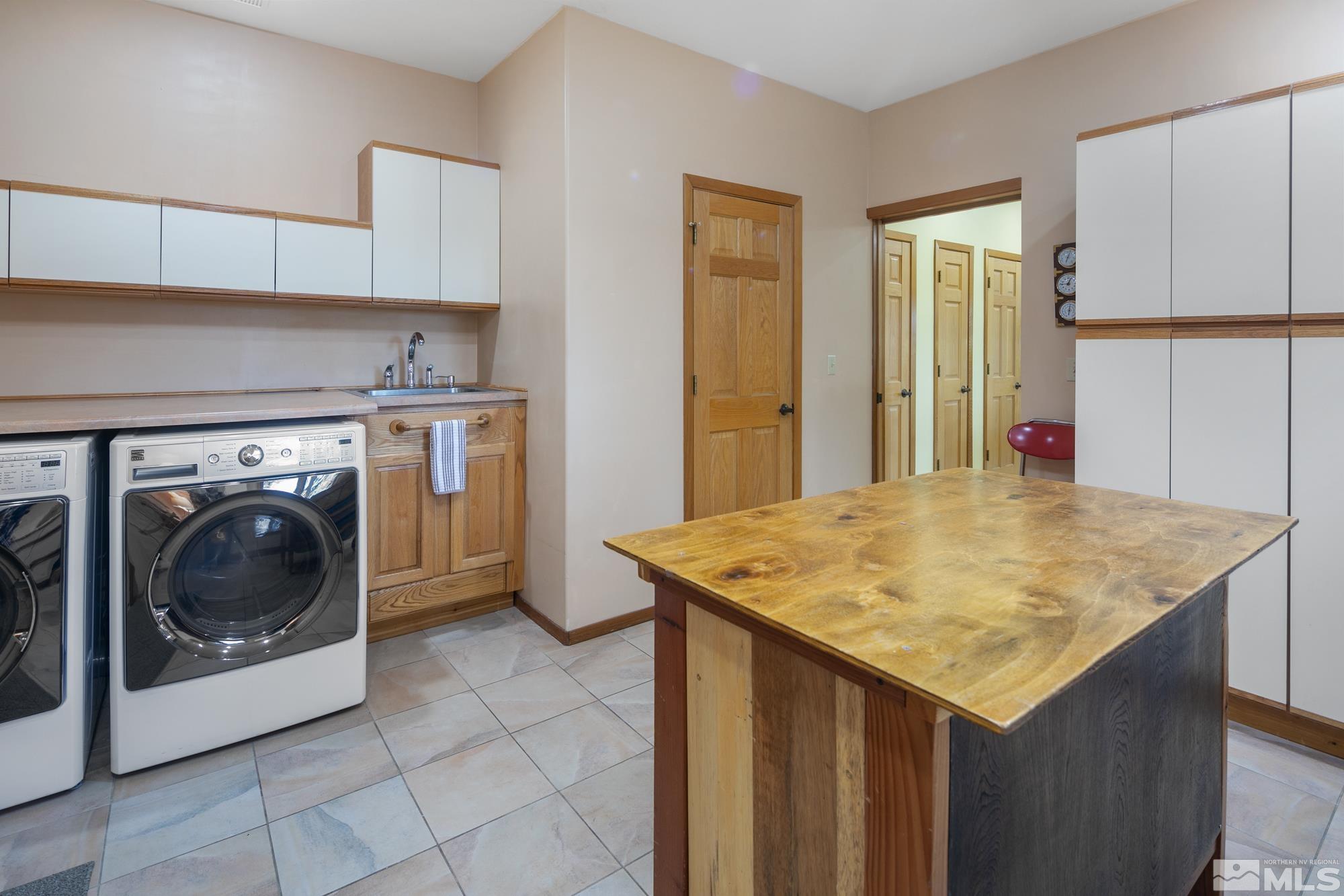 35 Austrian Pine Circle Reno, NV 89511 - Photo 33 of 39 a utility room with a sink a washer and dryer
