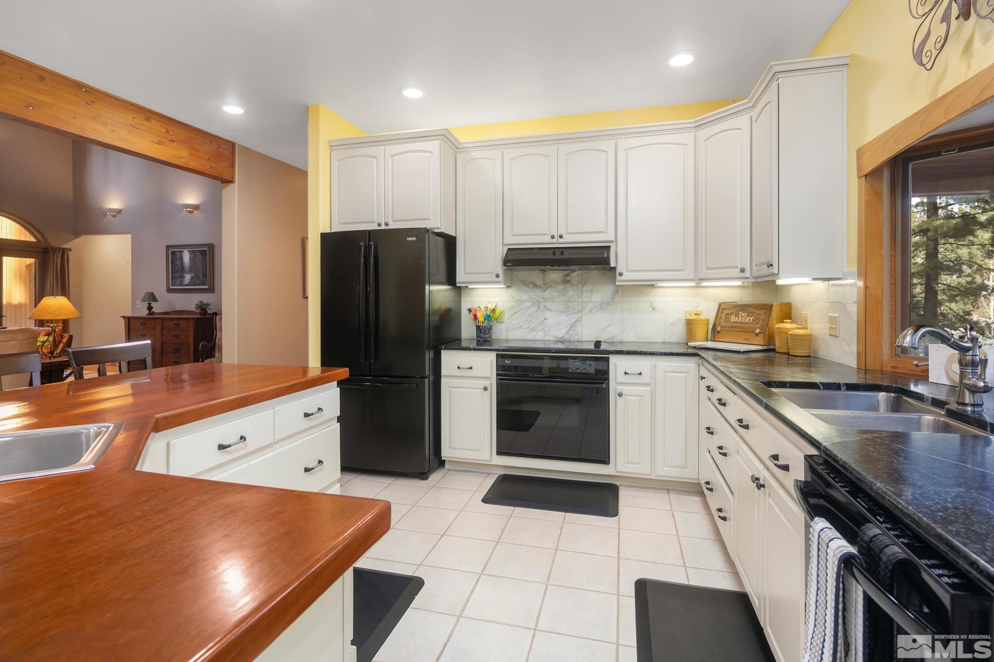 35 Austrian Pine Circle Reno, NV 89511 - Photo 8 of 39 a kitchen with a sink a stove and a refrigerator