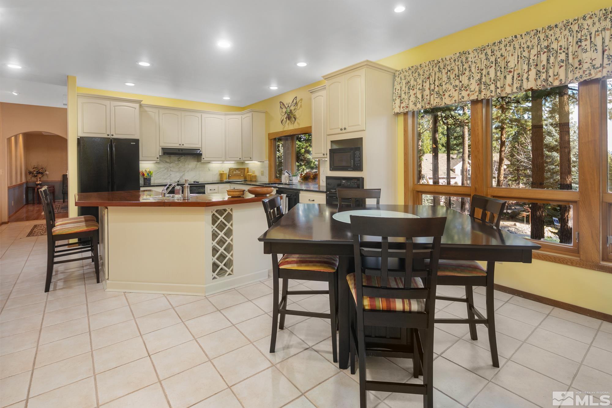 35 Austrian Pine Circle Reno, NV 89511 - Photo 10 of 39 a kitchen with stainless steel appliances granite countertop a stove top oven a sink a dining table and chairs