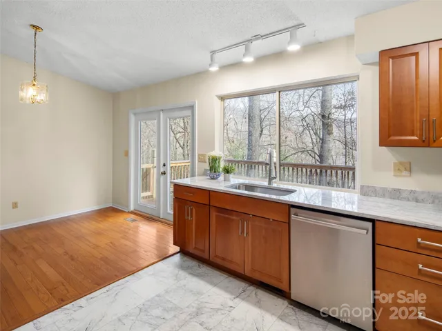a kitchen with granite countertop sink and window