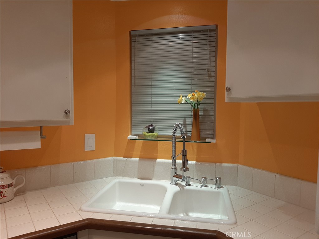 12592 Montecito Road, Unit 9 Seal Beach, CA 90740 - Photo 14 of 16 a bathroom with a sink and a mirror