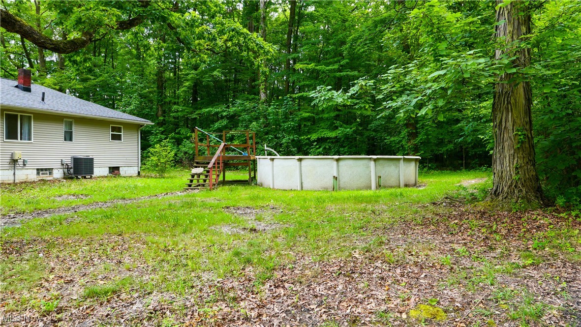 4869 Phillips Rice Road Cortland, OH 44410 - Photo 25 of 33 View of yard featuring an outdoor pool
