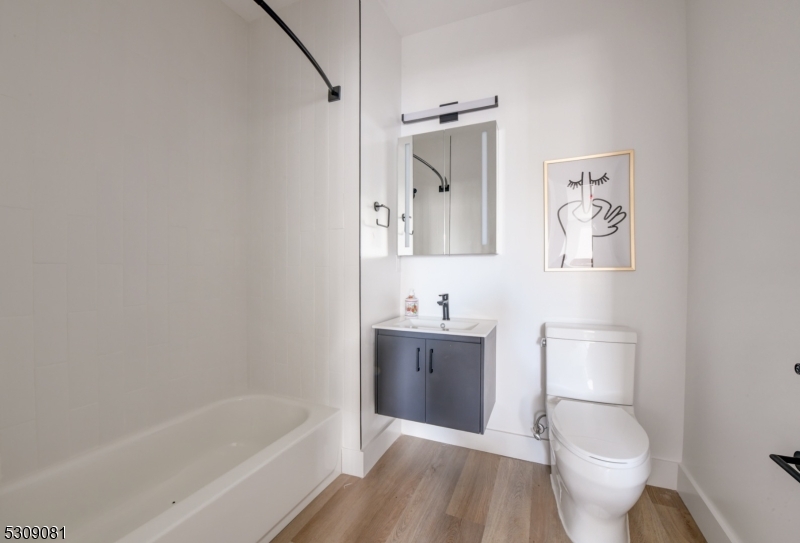 39 Madison Street Newark, NJ 07105 - Photo 13 of 33 a bathroom with a toilet sink and mirror