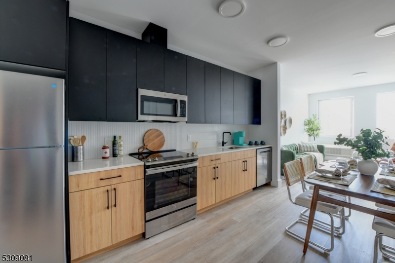 39 Madison Street Newark, NJ 07105 - Photo 15 of 33 a kitchen with a sink cabinets and stainless steel appliances