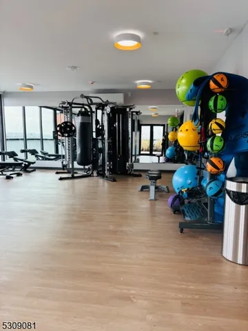 a room with lots of gym equipment and a chandelier