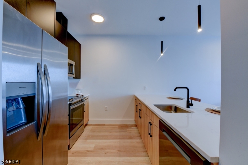 39 Madison Street Newark, NJ 07105 - Photo 4 of 33 a kitchen with stainless steel appliances granite countertop a sink and a refrigerator