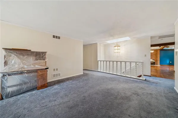 a view of a livingroom with an empty space and a fireplace