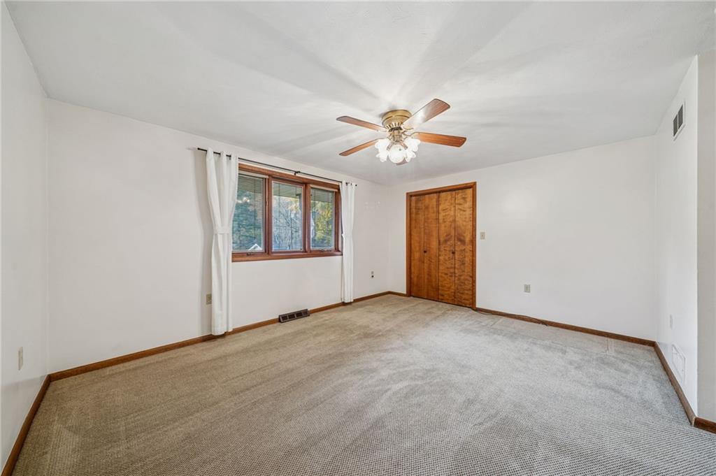 12219 Roth Drive Irwin, PA 15642 - Photo 29 of 49 an empty room with windows and chandelier fan