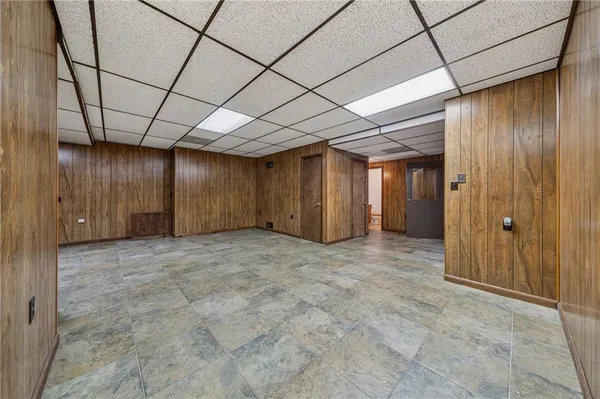 a view of empty room with wooden walls