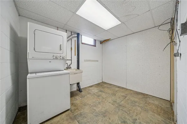 a utility room with cabinets washer and dryer