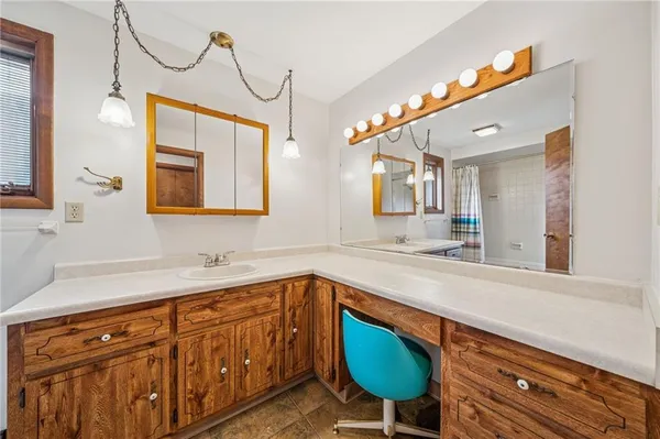 a bathroom with a sink a mirror and a bathtub